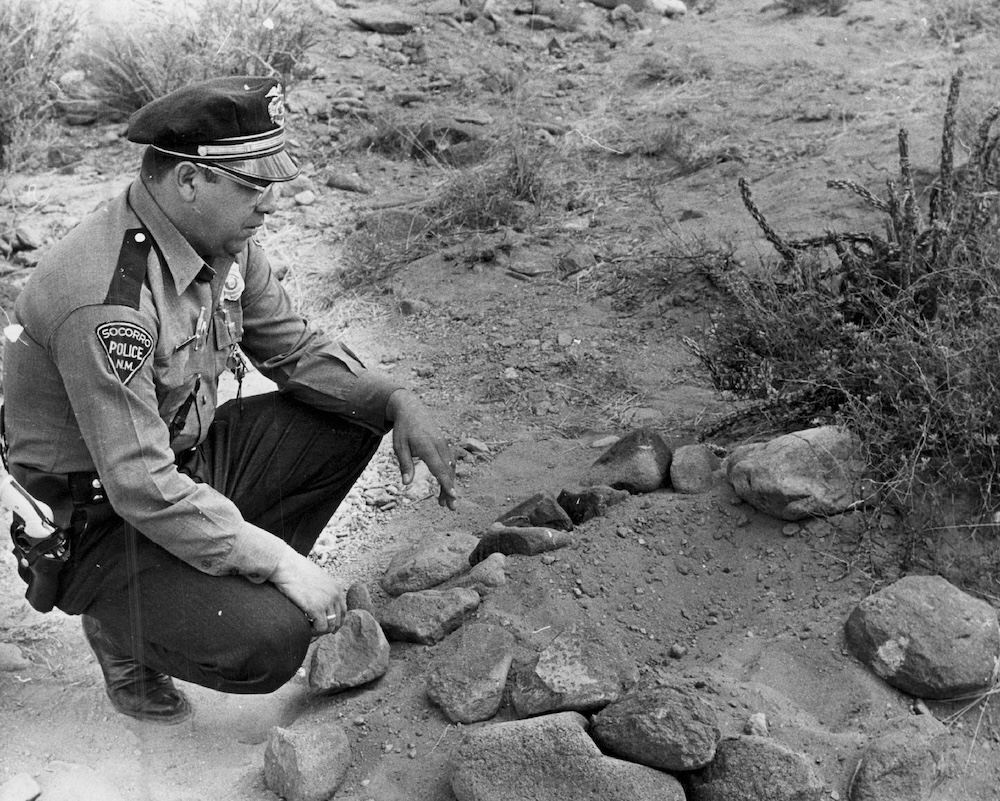 Historic photograph of Socorro police officer Lonnie Zamora examining the reported 1964 landing site